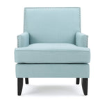 Fauteuil club en tissu clouté