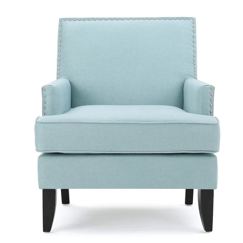 Fauteuil club en tissu clouté