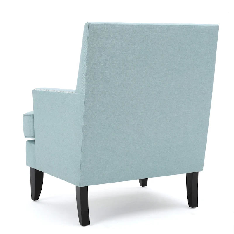 Fauteuil club en tissu clouté