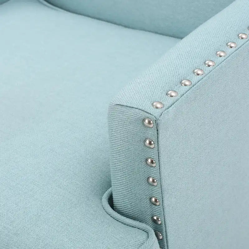 Fauteuil club en tissu clouté