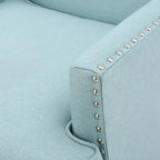 Fauteuil club en tissu clouté