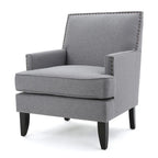 Fauteuil club en tissu clouté