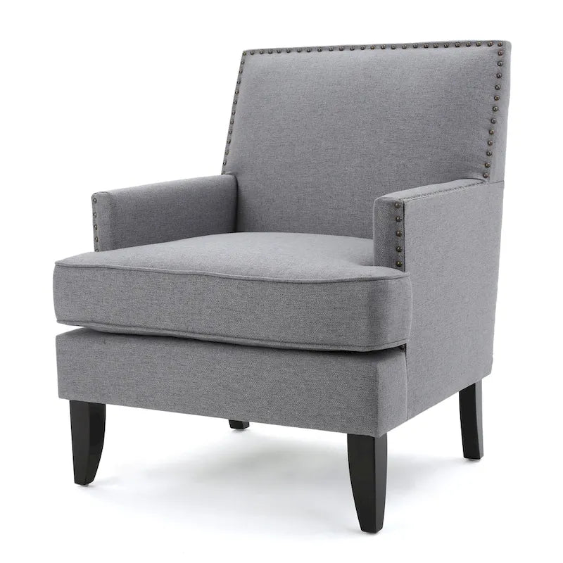 Fauteuil club en tissu clouté