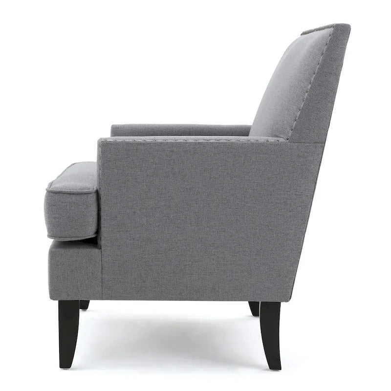 Fauteuil club en tissu clouté