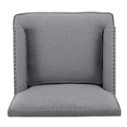 Fauteuil club en tissu clouté