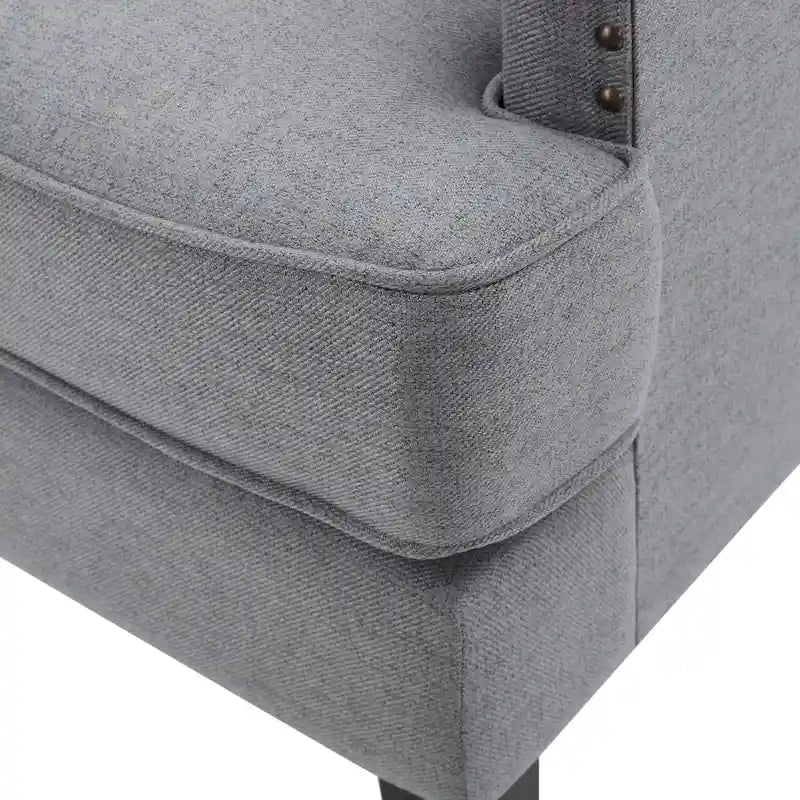 Fauteuil club en tissu clouté