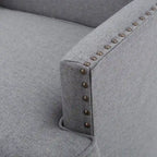Fauteuil club en tissu clouté