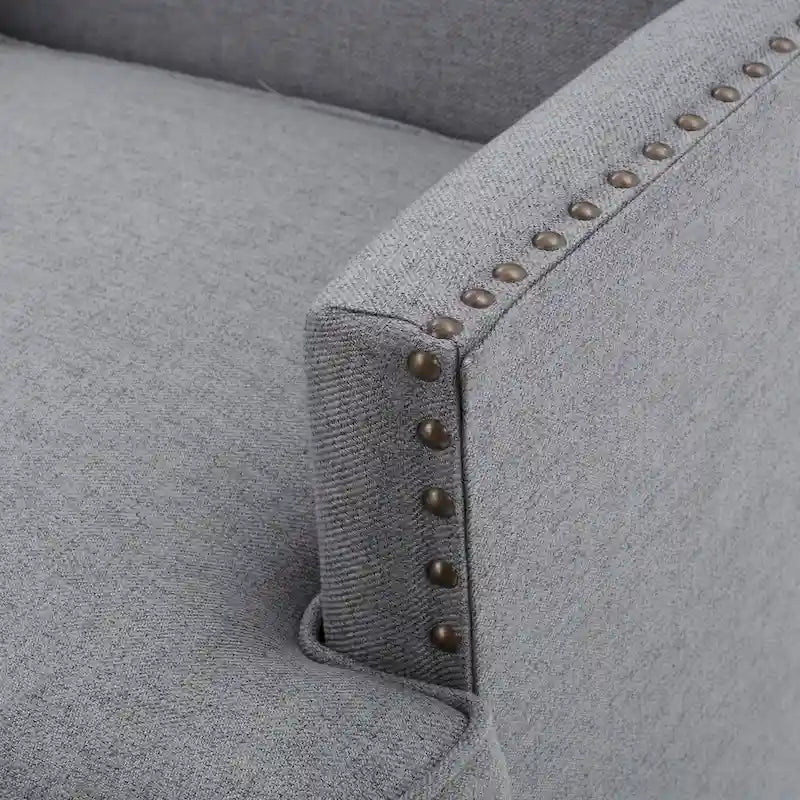 Fauteuil club en tissu clouté