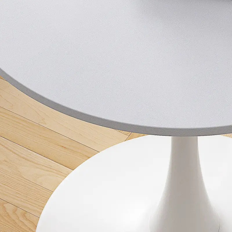 Table à manger moderne avec plateau rond et pied en métal